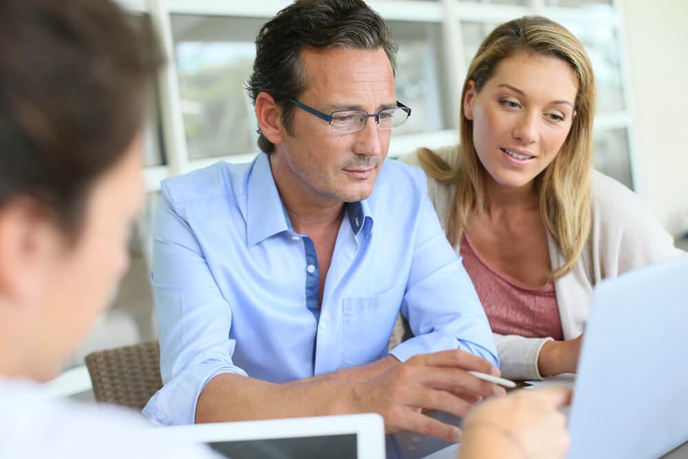 Consultants working with clients at a table